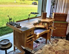 a workbench with many tools on it in front of a window