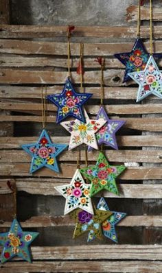 multicolored star ornaments hanging on wooden planks