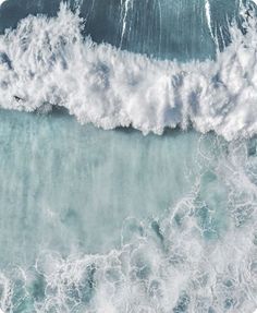 an aerial view of the ocean with waves