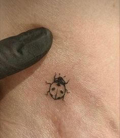 a ladybug tattoo on the chest