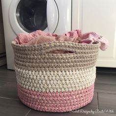 a laundry basket sitting next to a washing machine