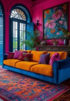 a brightly colored living room with blue doors and pink walls, colorful rugs on the floor