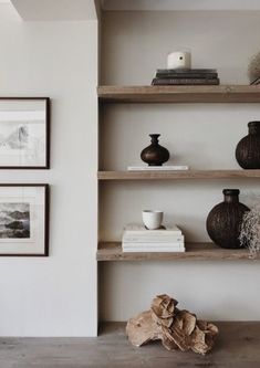 some shelves with vases and pictures on them