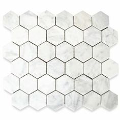 white marble hexagonal tiles with grey veining on the edges and one side