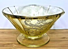 a glass bowl sitting on top of a wooden table