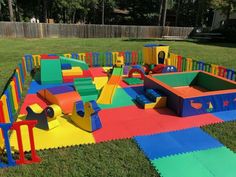 children's play area in the backyard with soft foam mats and colorful playground equipment