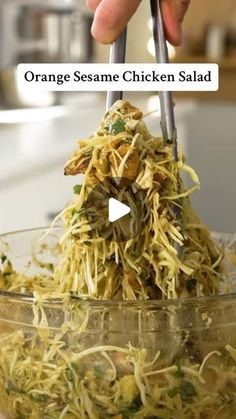 someone is using tongs to stir up some food in a bowl with the words orange sesame chicken salad