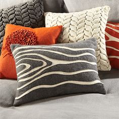 pillows on a couch with different colors and patterns