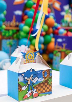 sonic the hedgehog themed birthday party with candy boxes and streamers in front of it