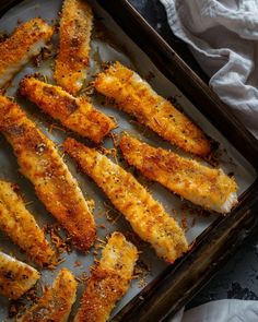 baked fish fillets on a baking sheet ready to be cooked in the oven for dinner