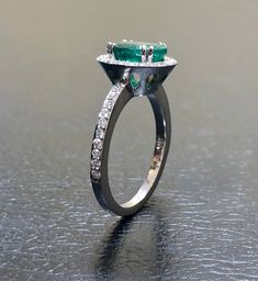 DeKara Designs Collection Our latest design! An elegant and lustrous Colombian Emerald surrounded by beautiful diamonds in a halo setting. Metal- 14K White Gold, .583. Stones- 1 Oval Colombian Emerald 1.25-1.40 Carats, 40 Round Diamonds, F-G color VS clarity, 0.30 carats. Latest of my creations. A beautiful Oval Colombian Emerald Halo Diamond Ring. The Emerald is a beautiful green and it is professionally prong set in between four double prongs. There are ten pave set round diamonds on each side Dazzling Oval Emerald Ring In Platinum, Luxury Marquise Emerald Ring With Diamonds, Exquisite Oval Emerald Ring In Platinum, Luxury Oval Emerald Cluster Ring, Luxury Oval Emerald Ring With Brilliant Cut, Luxury Oval Cluster Ring With Halo Setting, Luxury Oval Cluster Ring With Halo Design, Formal White Gold Emerald Ring With Halo, Luxury Platinum Emerald Ring With Halo Setting