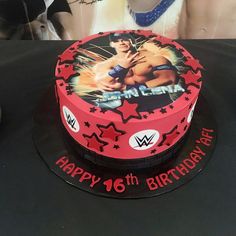 a birthday cake with an image of the wrestler on it