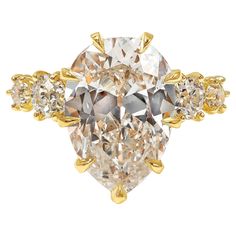 An antique style engagement ring, showcasing a 5.95 carats pear shape diamond certified by GIA as L color and SI1 clarity. Flanked by four old-mine cut diamonds weighing 0.83 carat total. Finely set on an 18K yellow gold mounting. Size 5.75 US, resizable upon request. Roman Malakov is a custom house, specializing in creating anything you can imagine. If you would like to receive a special quote on a custom piece, please message or call us. Sparkle Tips, Pear Shaped Diamond Engagement Rings, Antique Style Engagement Rings, Timeless Engagement Ring, Contemporary Engagement Rings, Pear Cut Engagement Rings, Pear Shaped Engagement Rings, Platinum Diamond Engagement Rings, Modern Engagement Rings