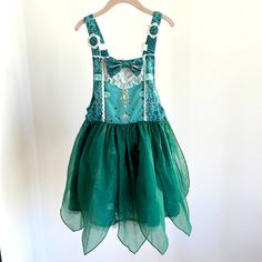 a green dress hanging on a hanger