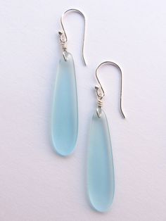 These earrings are handmade with Cultured Sea Glass pendants and are available in the following colors: Crystal Clear, Seafoam Green, Turquoise Bay, Pacific Blue, Royal Blue, Periwinkle light purple and Peridot light green They are elegant elongated teardrop shape. Each measures 2 1/4 inches, including earwire. All Sterling Silver components. Available by the pair or any combination and one of each color if for gift giving. Please inquire for custom selection. Teardrop Sea Glass Earrings With Ear Wire, Blue Periwinkle, Sea Glass Earrings, Sea Glass Pendant, Pacific Blue, Beach Glass, Seafoam Green, Green Turquoise, Glass Earrings