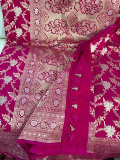 **SILK MARK CERTIFIED** **Gorgeous pure Banarasi Katan roopa sona Silk Saree with blouse piece (unstitched) in pink, silver and gold** **100% silk and high quality** **Direct from Banaras** Material: 100% Katan Silk Blouse piece: Included (Unstitched) Fall and Pico: YES Color: Pink, Silver And Gold Occasion: Festivals, Weddings, Cultural Events, Puja, Parties, Formal Gatherings, Family Functions, Graduations Experience the charm of this Handwoven Blue Banarasi Meenakari Katan Silk Saree, a beaut Luxury Resham Embroidered Katan Silk Saree, Luxury Banarasi Silk Shawl With Cutdana Details, Luxury Katan Silk Embroidered Fabric For Festive Occasions, Luxury Katan Silk Dupatta For Rituals, Luxury Katan Silk Traditional Wear With Zari Weaving, Luxury Katan Silk Fabric With Zari Work, Luxury Bollywood Style Katan Silk Fabric, Luxury Katan Silk Embroidered Fabric For Puja, Luxury Katan Silk Fabric With Pallu Detail