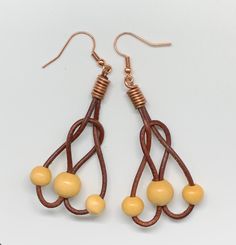 These lightweight fun earrings are approximately 2" long and 1" wide. Copper ear wires. Copper Components are Sealed with Protectaclear ProtectaClear is a clear, protective coating that is tough enough to protect jewelry and is safe for wear against skin. ProtectaClear is practically invisible once applied and will seal and protect jewelry from tarnish, oxidation, and corrosion Adjustable Wire Drop Earrings, Brown Wire Wrapped Drop Earrings, Brown Wire Wrapped Drop Beaded Earrings, Brown Teardrop Hoop Earrings With Ear Wire, Pierced Dangle Earrings With Wire, Adjustable Copper Wire Pierced Earrings, Adjustable Wire Wrap Drop Earrings, Adjustable Dangle Wrap Earrings For Jewelry Making, Brown Wire Wrapped Dangle Earrings