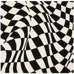 a black and white rug with an abstract design on it's side, in the shape of a checkerboard pattern