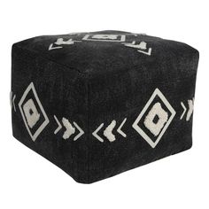 a black and white pouff with arrows on the side, sitting on top of a