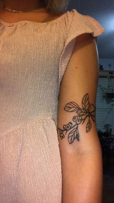 a woman with a flower tattoo on her arm