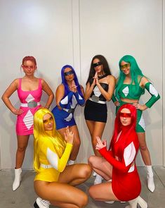 four women dressed in costumes posing for the camera