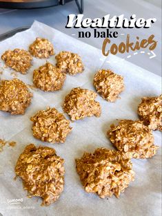 no bake cookies sitting on top of a piece of parchment paper next to an oven