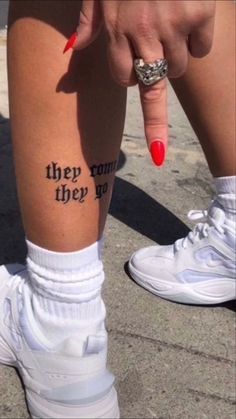 someone has tattoos on their legs with words