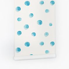 a white wall with blue polka dots on it