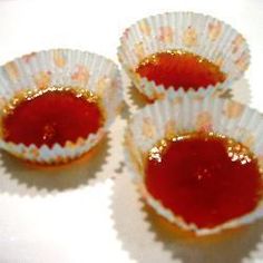 three cupcake tins filled with red jelly