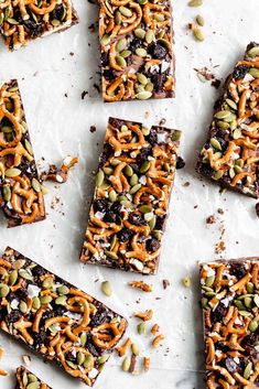 chocolate barkle bars with pretzels and pumpkin seeds on top, lined up in rows