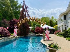 an outdoor swimming pool with balloons and streamers