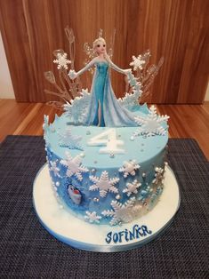 a frozen princess birthday cake with frosting and icing decorations on the top tier