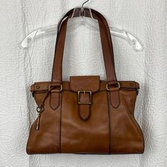 Fossil Women’s Cognac Leather Vtg Satchel 14 X 10 X 5 Full Grain Cowhide Beautiful Cognac Leather Heavy Duty Brass Hardware Shoulder Straps 10” Drop Flap Snap Closure Roomy Interior 1 Zip Pocket 2 Slip Pockets Approximately 14” X 10” X 5” Has Some Vintage Wear Minor Scratches On Body & Feet Excellent Pre-Loved Condition! Fossil Bags, Vintage Wear, Brass Hardware, Cognac, Snap Closure, Shoulder Straps, Fossil, Zip Pockets, Satchel