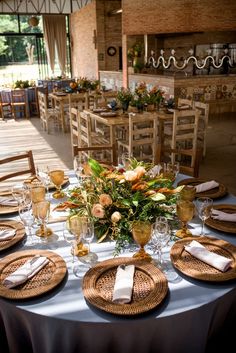 a table set with place settings and flowers