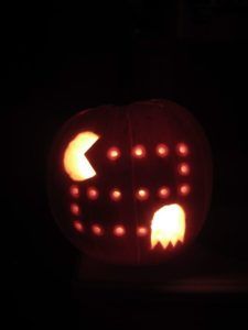 a carved pumpkin with an arrow in the middle