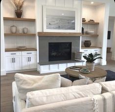 a living room filled with furniture and a fire place in the middle of a room