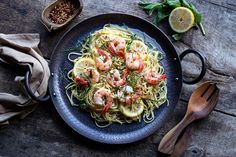 a plate of pasta with shrimp and lemon