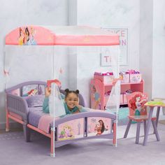 She'll drift off to sleep like a true Disney Princess in this canopy toddler bed by Delta Children. © Disney She'll drift off to sleep like a true Disney Princess in this canopy toddler bed by Delta Children. © Disney Easy assembly Uses a standard crib mattress (sold separately) Features two attached guardrails with low to the ground design at ideal kid-sized height Enables safe and easy access in and out of bed Colorful Disney Princess canopy creates a dream bedroom for your little one JPMA cer Princess Toddler Bed, Disney Princess Bedding, Princess Canopy, Disney Princess Theme, Big Kid Bed, Princess Bed, Crib Toddler Bed, Toddler Beds, Princess Theme