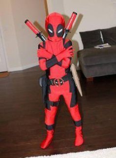 a deadpool costume is standing in the living room with two baseball bats on his shoulder