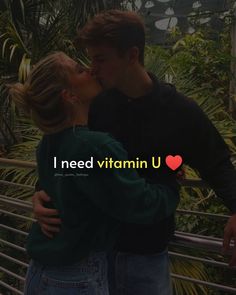 a man and woman kissing each other in front of some trees with the words i need vitamin u