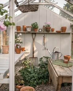 a greenhouse with potted plants and gardening tools