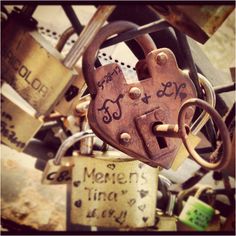 an old padlock with two heart shaped locks attached to it's sides and the words men's innards written on them