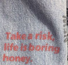 there is a message written on the back of a pair of socks that say take a risk, life is boring honey