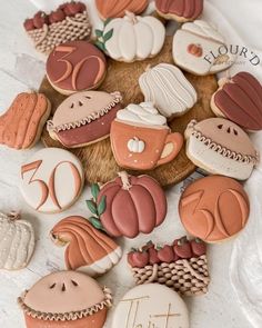 decorated cookies are arranged in the shape of pumpkins, apples and other fall decorations