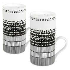 two coffee mugs with black and white designs on them