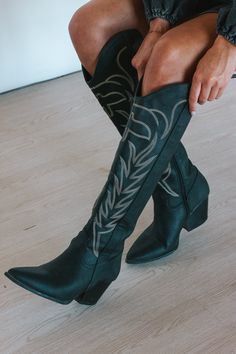 We are obsessed with the Take Me Downtown Black Cowgirl Boots. The contrast stitching is so unique and adds detail to what would be a boring boot without it. Fits True to Size Zipper on Side 2 1/2 inch heel Tall Black Cowgirl Boots, Black Boots Cowgirl, Tall Black Cowboy Boots, Black Cowgirl Boots Outfit, Cowgirl Boots Outfit Summer, Black Cowgirl Outfit, Mgk Concert, Gothic Cowgirl, Rodeo Outfits For Women