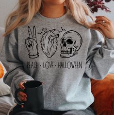 Peace Love Halloween Sweatshirt by LilCo Studio This dark humor Halloween tee is perfect for wearing all spooky season! Makes a great gift for the Halloween fan in your life. Welcome to LilCo Studio Etsy Shop! Each listing is for ONE (1) unisex t-shirt. Add additional items to cart to order more than one. COLORS: Heather Orange SIZES: Available in S-5XL. Size chart shown in listing photos. UNISEX fitment. Design is printed with a direct to garment process. Looks great and maintains its integrity Skeleton Cute, Halloween Inspired Outfits, Witchy Shirt, Love Halloween, Halloween Tees, Funny Halloween, Halloween Gift