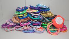 a pile of colorful bracelets sitting on top of a table