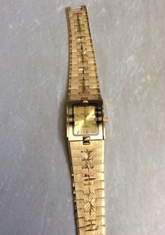 SUNBORN MEN'S LUXURY DRESS WATCH, WATER RESISTANT HIGH QUALITY, FOR LONGTIME USAGE & ENJOYMENT. THIS IS A NEW UNUSED VINTAGE WATCH, HAVING A RECTANGLE GOLD DIAL, SURROUNDED WITH A GOLD IMAGE AND BLACK OUTLINE BORDER. THE DIAL HAS GOLD INDEX HOURS AND A DAY AND DATE INDICATORS AT THE THIRD AND SIXTH HOUR POSITION, READY TO KEEP UOU UP WITH ACCURATE TIME, DAY AND DATE KEEPING. THIS WOULD MAKE AN AWESOME GIFT ITEM, THAT WILL KEEP GIVING. MEASUREMENTS: BEZEL/CASE 1 1/8" x 1" RECTANGLE, Dial 7/8" x 5/8", BAND WIDTH 7/8" AND FITS A STANDARD 8" WRIST, PERFECTLY. WE OFFER FREE SIZING IF A SMALLER WRIST SIZE IS NEEDED, JUST CONTACT US PRIOR TO PURCHASING VIA OF MESSAGES, FOR DETAILS NEEDED FOR THE CUSTOM SIZING PROCESS. WE SHIP FAST, THE NEXT BUSINESS DAY, FOR A QUICK DELIVERY TO YOU. MAY YOU HAVE Cheap Rectangular Dial Jewelry Gift, Dress Watch, Mens Luxury, Luxury Dress, Luxury Watches For Men, Wristwatch Men, Quick Delivery, Luxury Watch, New Vintage