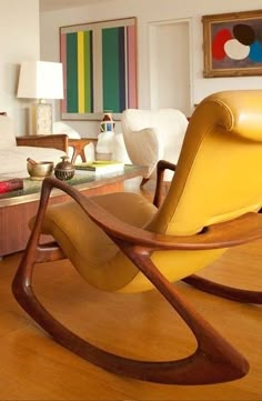 a yellow rocking chair in a living room